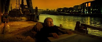 Movie still from “Micmacs” (2009), directed by Jean-Pierre Jeunet – A man sleeping on a boat in the water; Wide shot, High angle