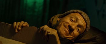 Movie still from “Micmacs” (2009), directed by Jean-Pierre Jeunet – A person laying on the ground; Close Up shot, High angle