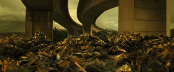 Movie still from “Micmacs” (2009), directed by Jean-Pierre Jeunet – A pile of debris next to a bridge; Extreme Wide shot, High angle