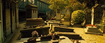 Movie still from “Micmacs” (2009), directed by Jean-Pierre Jeunet – A cemetery with a bunch of graves in it; Extreme Wide shot, High angle