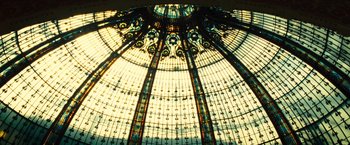 Movie still from “Micmacs” (2009), directed by Jean-Pierre Jeunet – A stained - glass dome is shown in the sunlight; Extreme Wide shot, Low angle