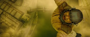 Movie still from “Micmacs” (2009), directed by Jean-Pierre Jeunet – A person hanging from the side of a building; Wide shot, Overhead angle