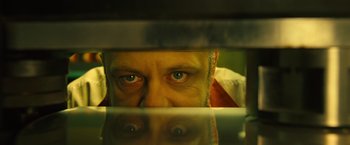 Movie still from “Micmacs” (2009), directed by Jean-Pierre Jeunet – A person's eyes looking through a mirror; Extreme Close Up shot, Overhead angle