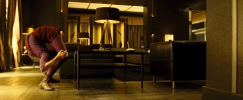 Movie still from “Micmacs” (2009), directed by Jean-Pierre Jeunet – A living room filled with furniture next to a window; Wide shot, High angle