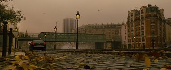 Movie still from “Micmacs” (2009), directed by Jean-Pierre Jeunet – A view of a street light and a bridge in the background; Extreme Wide shot, High angle