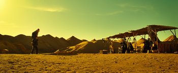Movie still from “Micmacs” (2009), directed by Jean-Pierre Jeunet – A view of a desert landscape with mountains in the background; Extreme Wide shot, Low angle