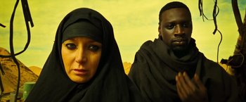 Movie still from “Micmacs” (2009), directed by Jean-Pierre Jeunet – A woman and a man in a black headscarf; Close Up shot, Low angle