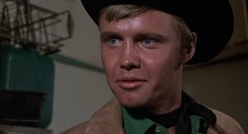 Movie still from “Midnight Cowboy” (1969), directed by John Schlesinger – A person wearing a cowboy hat; Close Up shot, Over the shoulder angle