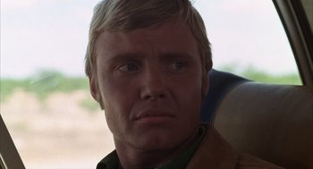 Movie still from “Midnight Cowboy” (1969), directed by John Schlesinger – A man's face in a car; Close Up shot, Low angle