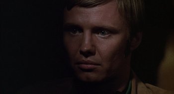 Movie still from “Midnight Cowboy” (1969), directed by John Schlesinger – A person's face in the dark; Close Up shot, Over the shoulder angle