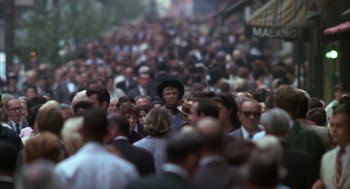 Movie still from “Midnight Cowboy” (1969), directed by John Schlesinger – A crowd of people walking down a street; Wide shot, High angle