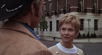 Movie still from “Midnight Cowboy” (1969), directed by John Schlesinger – A man and a woman standing next to each other on the street; Close Up shot, Over the shoulder angle