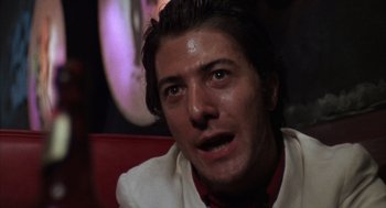 Movie still from “Midnight Cowboy” (1969), directed by John Schlesinger – A person wearing a white shirt; Close Up shot, Low angle