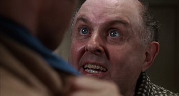 Movie still from “Midnight Cowboy” (1969), directed by John Schlesinger – A man's face as he looks at the camera; Close Up shot, Over the shoulder angle