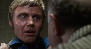 Movie still from “Midnight Cowboy” (1969), directed by John Schlesinger – A person looking into a mirror; Close Up shot, Over the shoulder angle