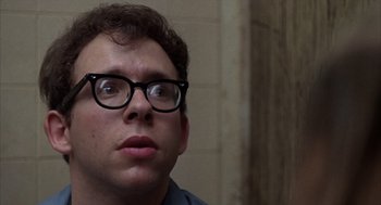 Movie still from “Midnight Cowboy” (1969), directed by John Schlesinger – A person wearing glasses and looking up; Close Up shot, Low angle