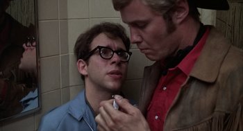 Movie still from “Midnight Cowboy” (1969), directed by John Schlesinger – Two men are looking at each other in a bathroom; Close Up shot, Over the shoulder angle