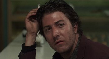 Movie still from “Midnight Cowboy” (1969), directed by John Schlesinger – A person with a cigarette in his ear; Close Up shot, Low angle