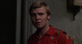 Movie still from “Midnight Cowboy” (1969), directed by John Schlesinger – A person wearing a red shirt; Close Up shot, Over the shoulder angle
