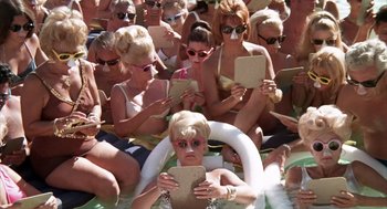 Movie still from “Midnight Cowboy” (1969), directed by John Schlesinger – A group of women sitting on the side of a swimming pool; Wide shot, High angle