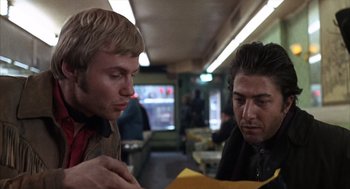 Movie still from “Midnight Cowboy” (1969), directed by John Schlesinger – Two men looking at a piece of paper in a restaurant; Close Up shot, Over the shoulder angle