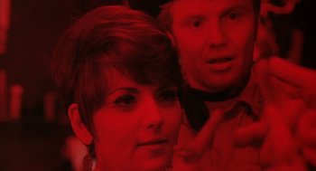 Movie still from “Midnight Cowboy” (1969), directed by John Schlesinger – A man and a woman in a red room; Close Up shot, Over the shoulder angle