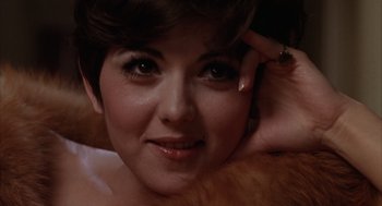 Movie still from “Midnight Cowboy” (1969), directed by John Schlesinger – A woman's face with her hand on her head; Close Up shot, Low angle