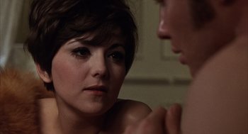 Movie still from “Midnight Cowboy” (1969), directed by John Schlesinger – A woman looking at a man in the mirror; Close Up shot, Over the shoulder angle
