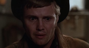 Movie still from “Midnight Cowboy” (1969), directed by John Schlesinger – A person wearing a cowboy hat; Close Up shot, Over the shoulder angle