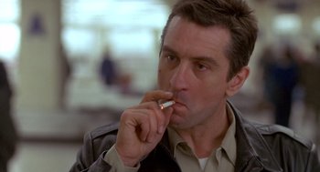 Movie still from “Midnight Run” (1988), directed by Martin Brest – A person with a cigarette in his mouth; Close Up shot, Low angle