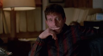 Movie still from “Midnight Run” (1988), directed by Martin Brest – A person with his hand on his chin; Close Up shot, Low angle