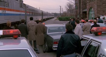 Movie still from “Midnight Run” (1988), directed by Martin Brest – A group of people standing next to a train; Extreme Wide shot, High angle