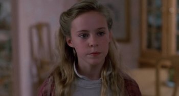 Movie still from “Midnight Run” (1988), directed by Martin Brest – A young girl with long blonde hair looking at the camera; Close Up shot, High angle