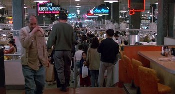 Movie still from “Midnight Run” (1988), directed by Martin Brest – A crowd of people walking around a store; Wide shot, High angle