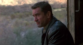 Movie still from “Midnight Run” (1988), directed by Martin Brest – A person wearing a leather jacket; Close Up shot, Over the shoulder angle