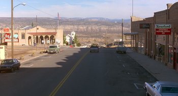Movie still from “Midnight Run” (1988), directed by Martin Brest – Cars driving down a street in a small town; Extreme Wide shot, High angle
