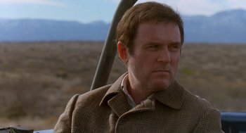 Movie still from “Midnight Run” (1988), directed by Martin Brest – A person wearing a jacket; Close Up shot, Over the shoulder angle