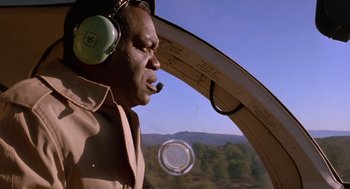 Movie still from “Midnight Run” (1988), directed by Martin Brest – A man in a helicopter looking out a window; Close Up shot, Low angle