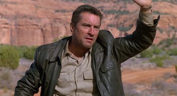 Movie still from “Midnight Run” (1988), directed by Martin Brest – A person wearing a leather jacket; Medium shot, Low angle
