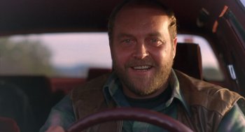 Movie still from “Midnight Run” (1988), directed by Martin Brest – A person driving a car; Close Up shot, Low angle