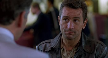 Movie still from “Midnight Run” (1988), directed by Martin Brest – A person wearing a leather jacket; Close Up shot, Over the shoulder angle