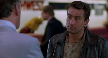 Movie still from “Midnight Run” (1988), directed by Martin Brest – A person wearing a leather jacket; Close Up shot, Over the shoulder angle