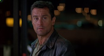 Movie still from “Midnight Run” (1988), directed by Martin Brest – A person wearing a leather jacket; Close Up shot, Over the shoulder angle