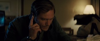 Movie still from “Midnight Special” (2016), directed by Jeff Nichols – A man is talking on a cell phone; Close Up shot, High angle