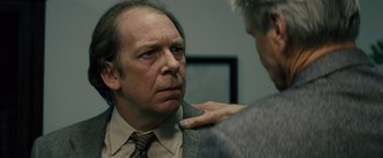 Movie still from “Midnight Special” (2016), directed by Jeff Nichols – A man in a suit and tie is looking at another man in a suit and tie; Close Up shot, Over the shoulder angle