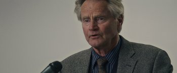 Movie still from “Midnight Special” (2016), directed by Jeff Nichols – An older man wearing a jacket and a tie; Close Up shot, Low angle