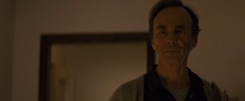 Movie still from “Midnight Special” (2016), directed by Jeff Nichols – An older man is looking at the camera; Close Up shot, Low angle