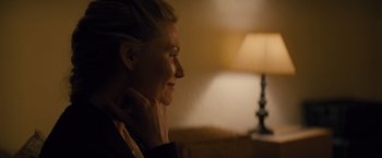 Movie still from “Midnight Special” (2016), directed by Jeff Nichols – A woman sitting in front of a table with a lamp; Close Up shot, Over the shoulder angle