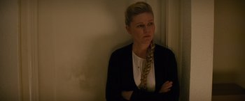 Movie still from “Midnight Special” (2016), directed by Jeff Nichols – A woman standing in front of a wall with her arms crossed; Close Up shot, Over the shoulder angle