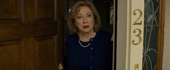 Movie still from “Midnight Special” (2016), directed by Jeff Nichols – An older woman standing in front of a door looking at the camera; Close Up shot, Over the shoulder angle